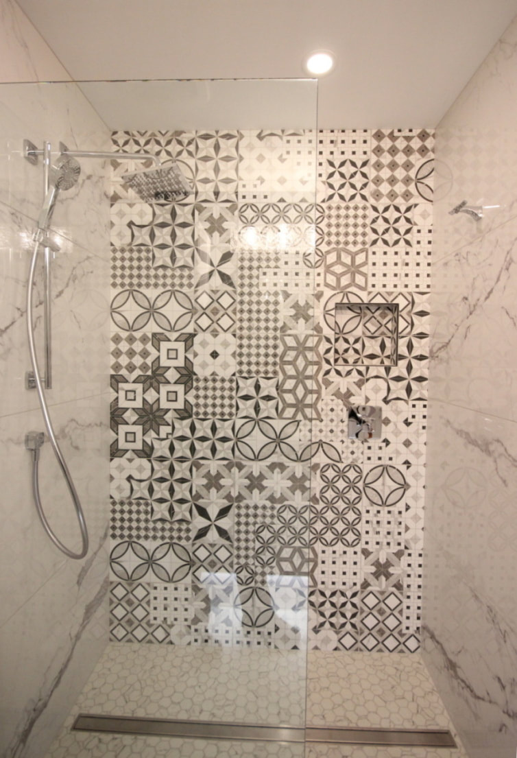 Cement tiles accent wall in the curbless walk-in shower with the liner drain. Renovation to Perfection