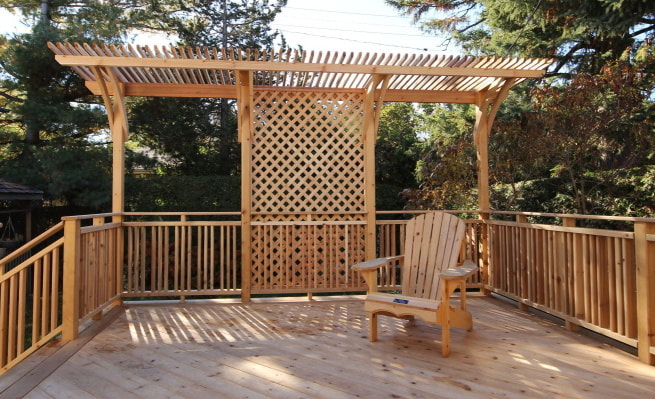 Custom cedar deck with small pergola in Ottawa by Renovation to Perfection.