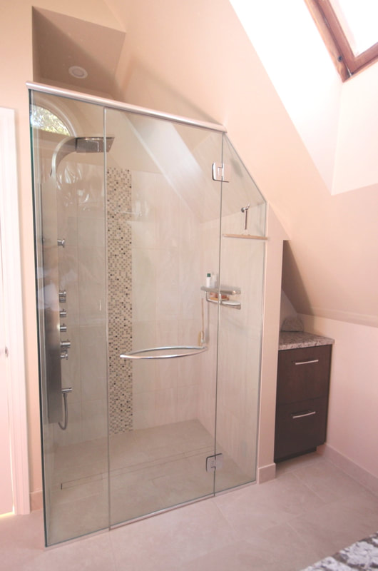 Custom bathroom with curbless, linear drain shower, Invisia shampoo shelf grab bar and mosaic detail on the wall in Ottawa by Renovation to Perfection.