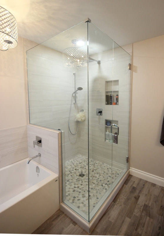 Bathroom renovation with the 32 sq.ft. shower with 2 custom niches, pebble mosaic and custom glass enclosure in Kanata by Renovation to Perfection.